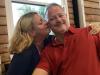 Kim plants a smooch on hubby Dave's (Fager's mgr.) cheek at Fast Eddie's.